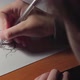 Close-up girls arm drawing a boy on a white paper by pen - VideoHive Item for Sale
