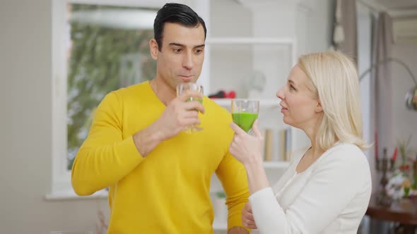 Portrait of Handsome Middle Eastern Man and Beautiful Caucasian Woman Drinking Healthful Vegetarian