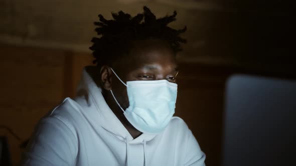 a Black Man Works at a Laptop Closeup of His Face