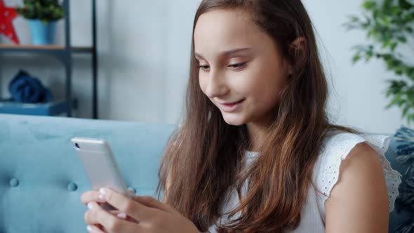 Beautiful Teenage Girl Texting Touching Screen Messaging Enjoying Online Communication with