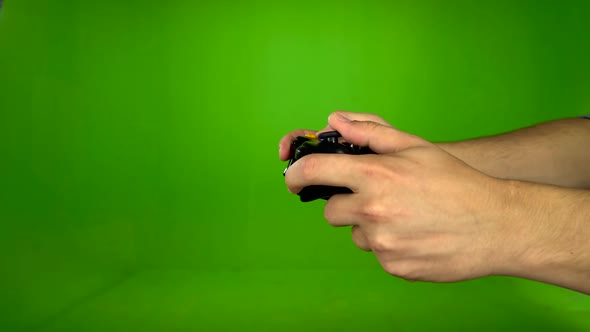 Closeup of Gamer Hands Playing Pressing Joystick. Green Screen. Side View