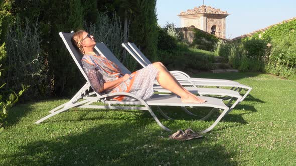 Resting sitting in a lounge chair in a small village in Tuscany, Italy, Europe.