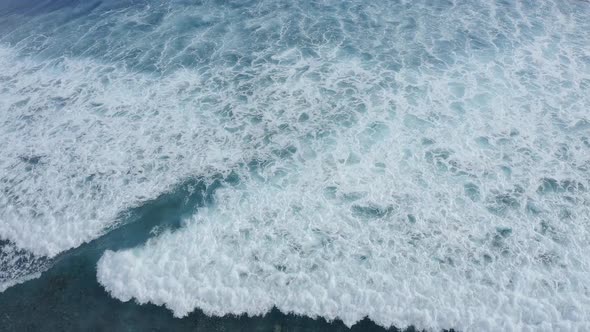 Slowmotion Top Down Aerial View of the Ocean Giant Waves Foaming and Splashing