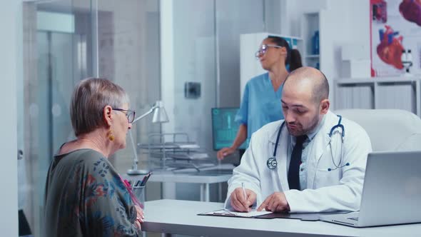 Physician Consulting an Elderly Retired Woman