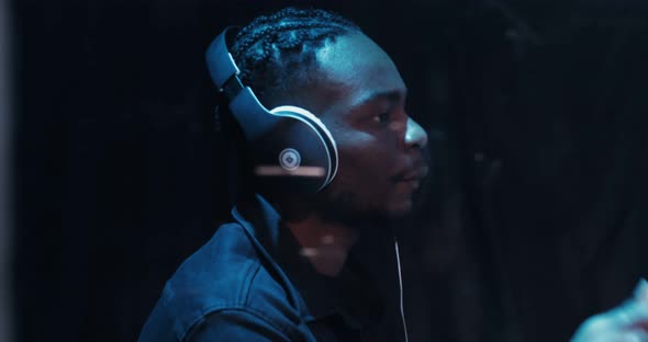 African American Man Energetically Plays the Drum Participates in a Concert