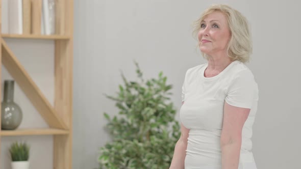 Sporty Senior Old Woman Working Out with Dumbbells at Home