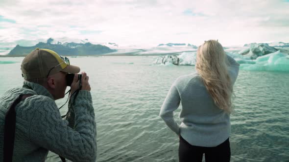 Caucasian Woman Posing In Photographer At Jokulsarlon Glacier In Iceland. - medium shot