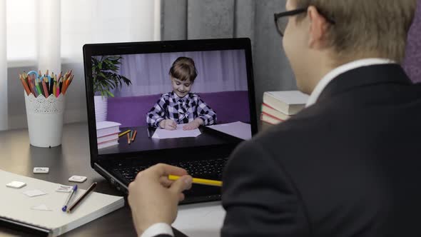 Man Teacher Makes Video Call on Laptop with Children Pupil. Distance Education