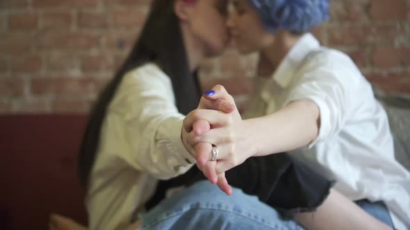 Defocused Blurry Image of Young Womans Kissing in Modern Interior Spbd