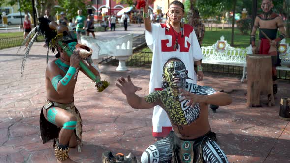 Mayan dancers performing to live drums outside in a park in Valladolid, Mexico.