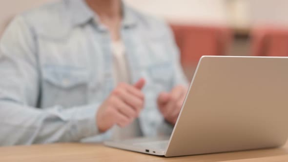 Man Showing Thumbs Up While Using Laptop Close Up