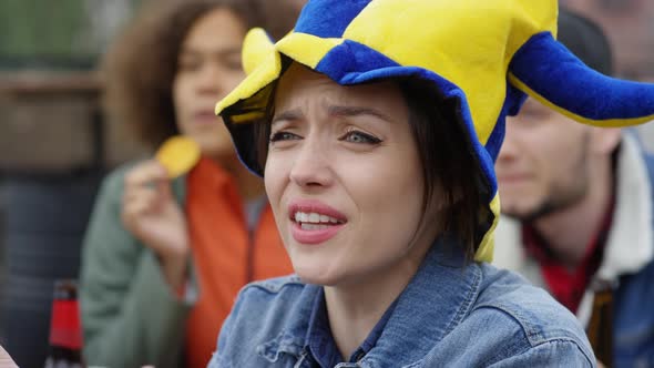 Young Woman Watching Sports Match and Yelling in Excitement