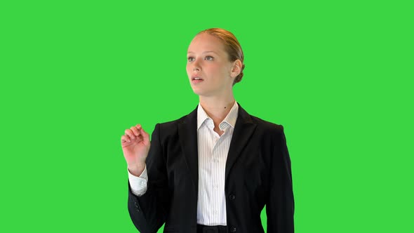 Blond Woman Interacting with a Virtual Reality Screen on a Green Screen Chroma Key