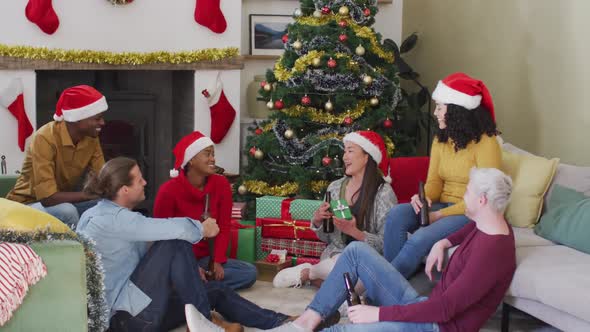 Happy diverse group of friends sharing with presents at christmas time