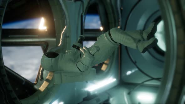 Astronaut Inside the Orbital Space Station alt