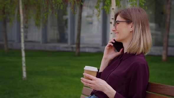 Business Woman portrait talking on mobile phone and holding coffee cup.