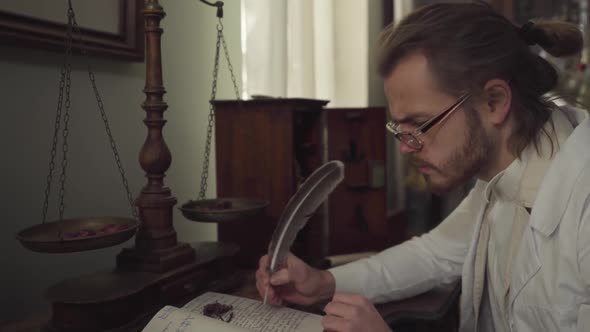 Side View of Concentrated Caucasian Man Sitting in Front of Vintage Weighting Machine with Dried