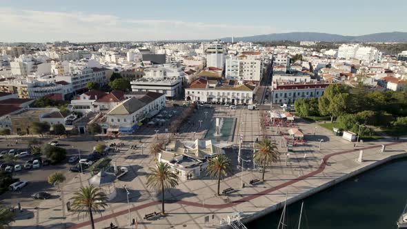 Square with fountain in Portimao seafront promenade, Portugal. Aerial circling