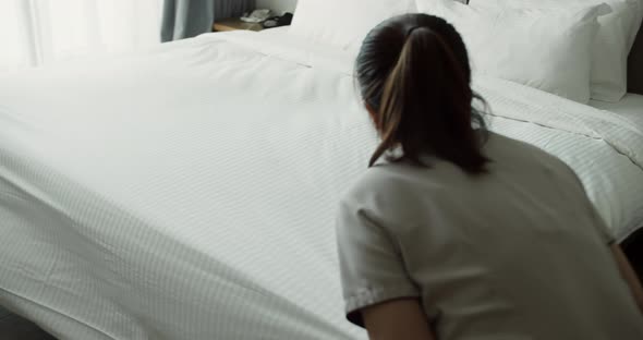 Employees Two Maids of the Hotel Professionally Make the Bed in the Client's Room