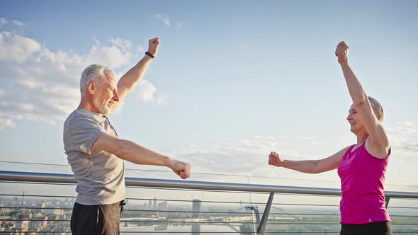 Greyhaired Pensioners Knead Shoulders at Viewpoint