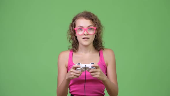 Young Beautiful Nerd Woman Focusing While Playing Games