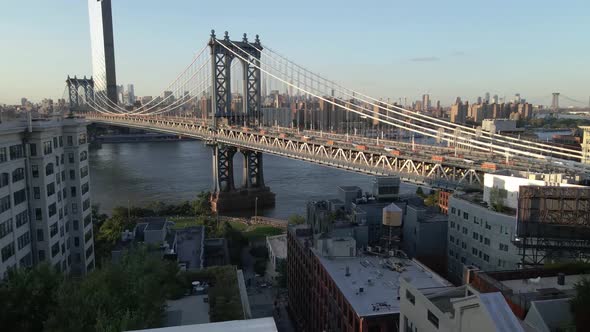 Pushing drone shot of the Brooklyn bridge located in Brooklyn New York during sunset, Golden Hour. s