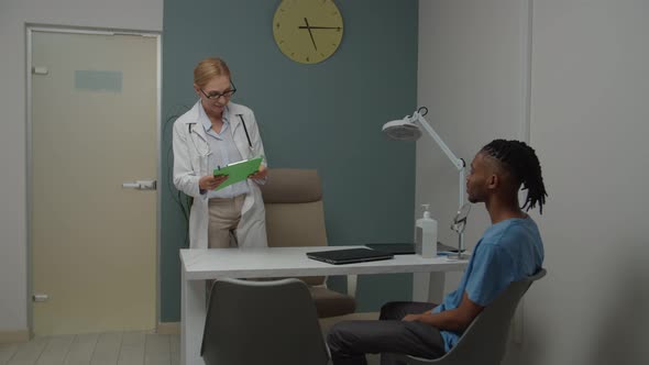Young Adult Patient Greeting Female Physician in Doctor's Office
