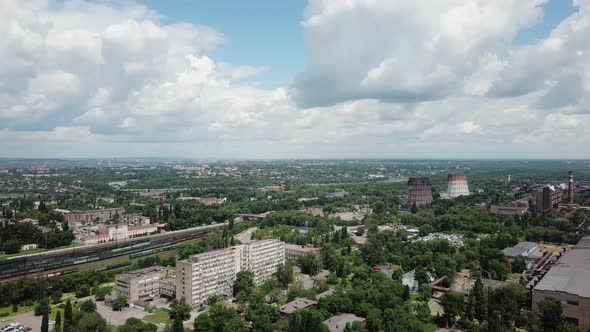 Blue sky with white clouds A sunny summer day over an industrial city.Drone aerial high angle view