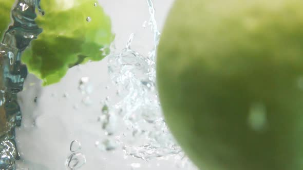 Two Apple Halfs Fall Down Into Water