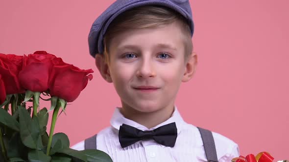 Little Boy With Bouquet of Roses and Gift Box Ready for Date, Valentines Day
