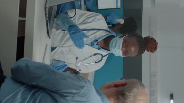 Vertical Video Black Professional Doctor Showing Bottle of Pills