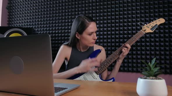 Teenager Female Learning Play Guitar at Home Using Online Lessons