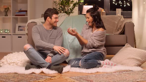 Happy Couple with Gift Box at Home