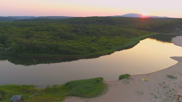 Aerial View of Red Sunset Over Mountains, Green Forests and Veleka River Mouth Flowing in To the Sea