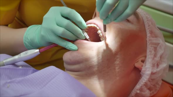 Close Up Female Hands Professional Doctor Stomatologist at Work. Person Undergoes a Medical