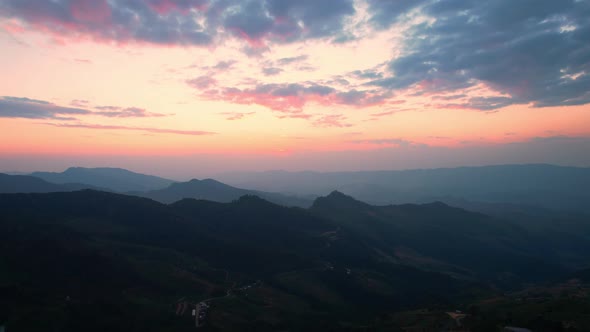4K Aerial view over mountain scenery at rural Thailand at sunset