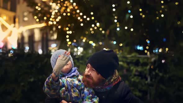 Happy Father and Son at Christmas Time Outdoor in a City Center