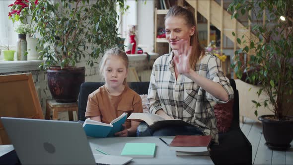 Mom and Girl are Engaged with a Tutor Via the Internet