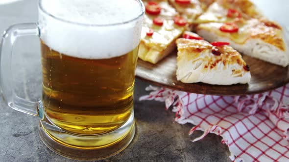 Delicious pizza with a glass of beer