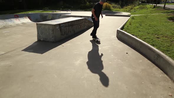 A young skateboarder going off ramps at a skate park.