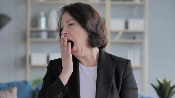 Tired Old Businesswoman Yawning