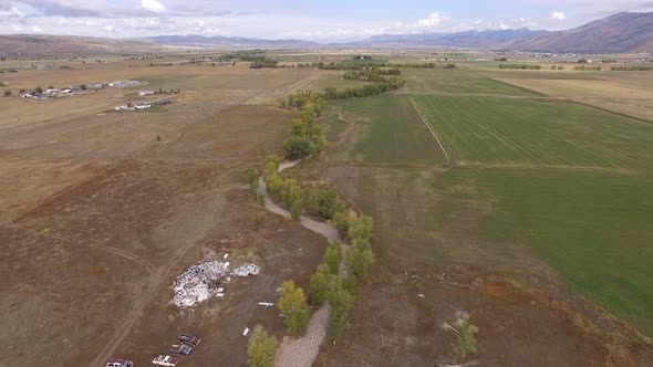 Aerial view flying over farmland in Wyoming viewing houses