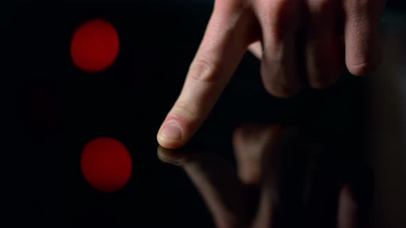 Macro Video of Man Finger Touching Black Surface