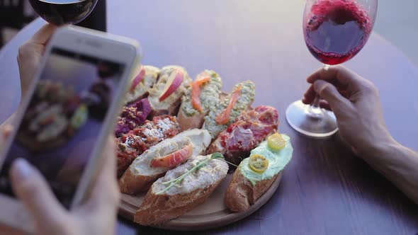 Closeup Woman Taking Photos On Phone Of Food In Restaurant 