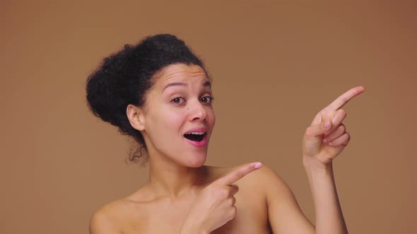 Beauty Portrait of Young African American Woman Pointing Side Hand for Something Nods and Shows