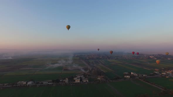 Hot air balloons flying over the fields in Luxor