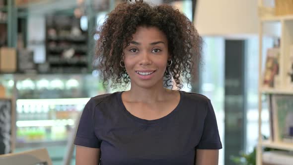 Portrait of Young African Woman with Yes By Head Shake