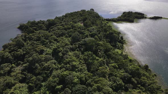 Aerial footage of a small peninsula at lake Arenal in central Costa Rica during green season. Wetlan