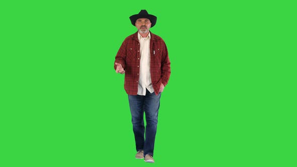 Ranch Owner in a Cowboy Hat Walking and Telling a Story on a Green Screen Chroma Key