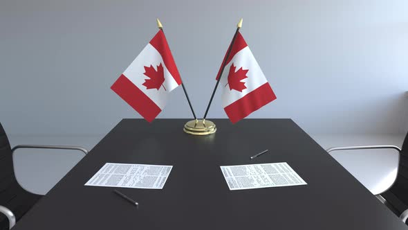 Flags of Canada and Papers on the Table